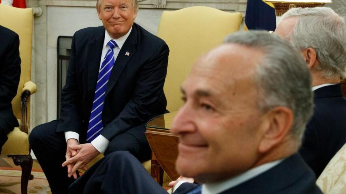 In this Sept. 6, 2017 photo, President Donald Trump and Senate Minority Leader Chuck Schumer, D-N.Y., during a meeting with other Congressional leaders in the Oval Office of the White House in Washington.