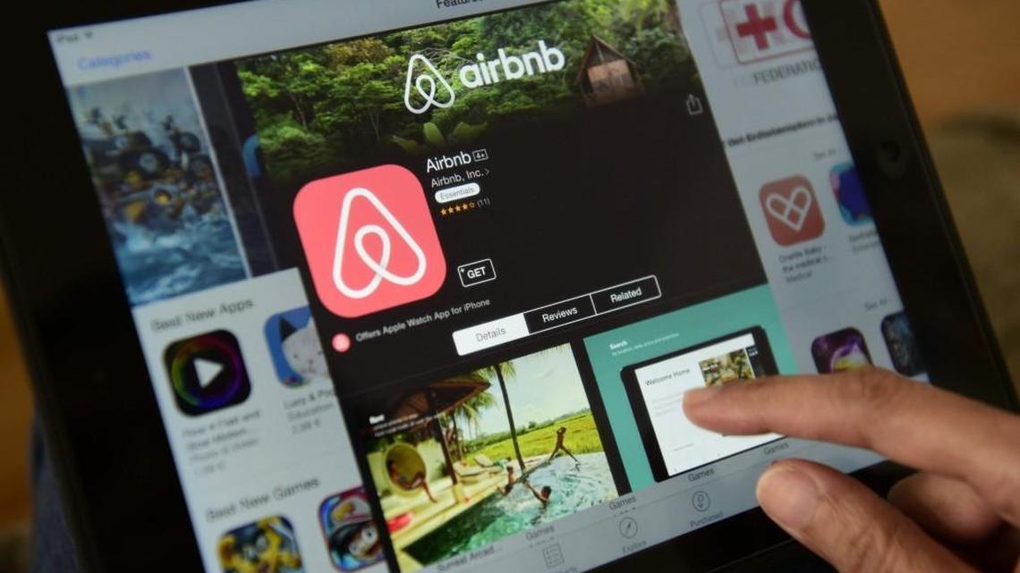 This file photo taken on April 28, 2016, shows a woman browsing the site of home-sharing giant Airbnb on a tablet in Berlin.