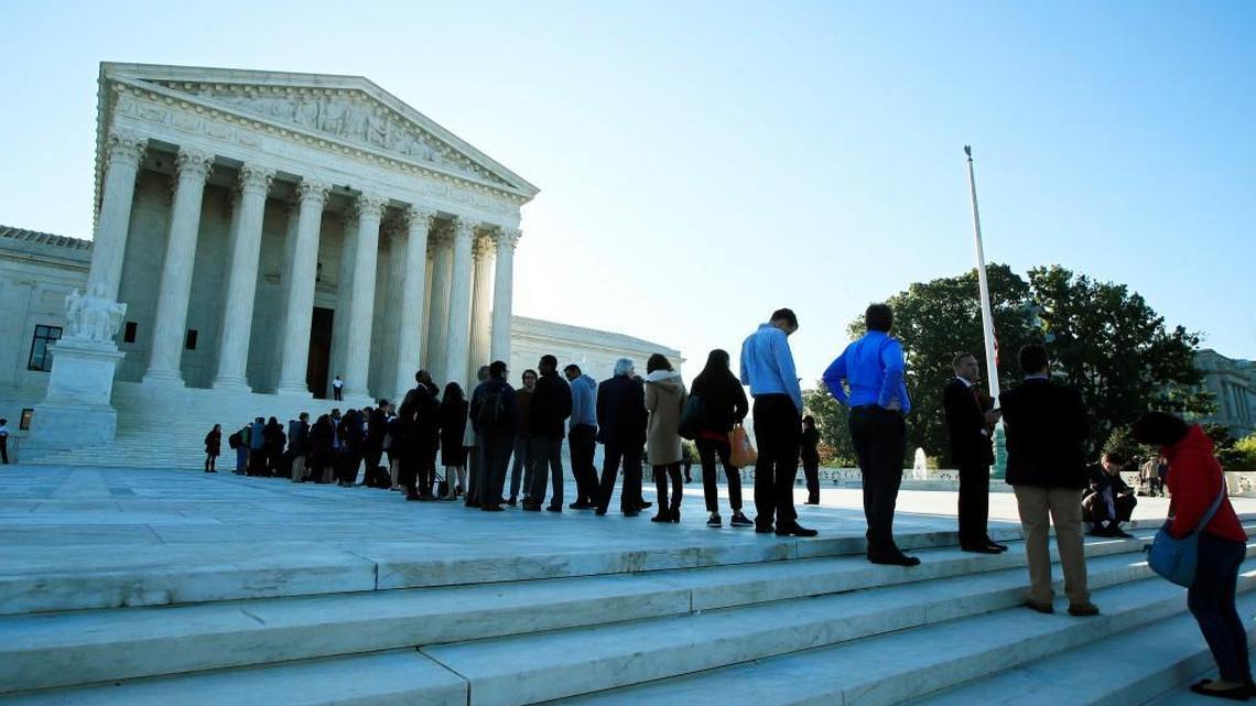 People are lined up outside the U.S. Supreme Court in Washington, Tuesday, Oct. 3, 2017. The Supreme Court hears arguments in a case about political maps in Wisconsin that could affect elections across the country.