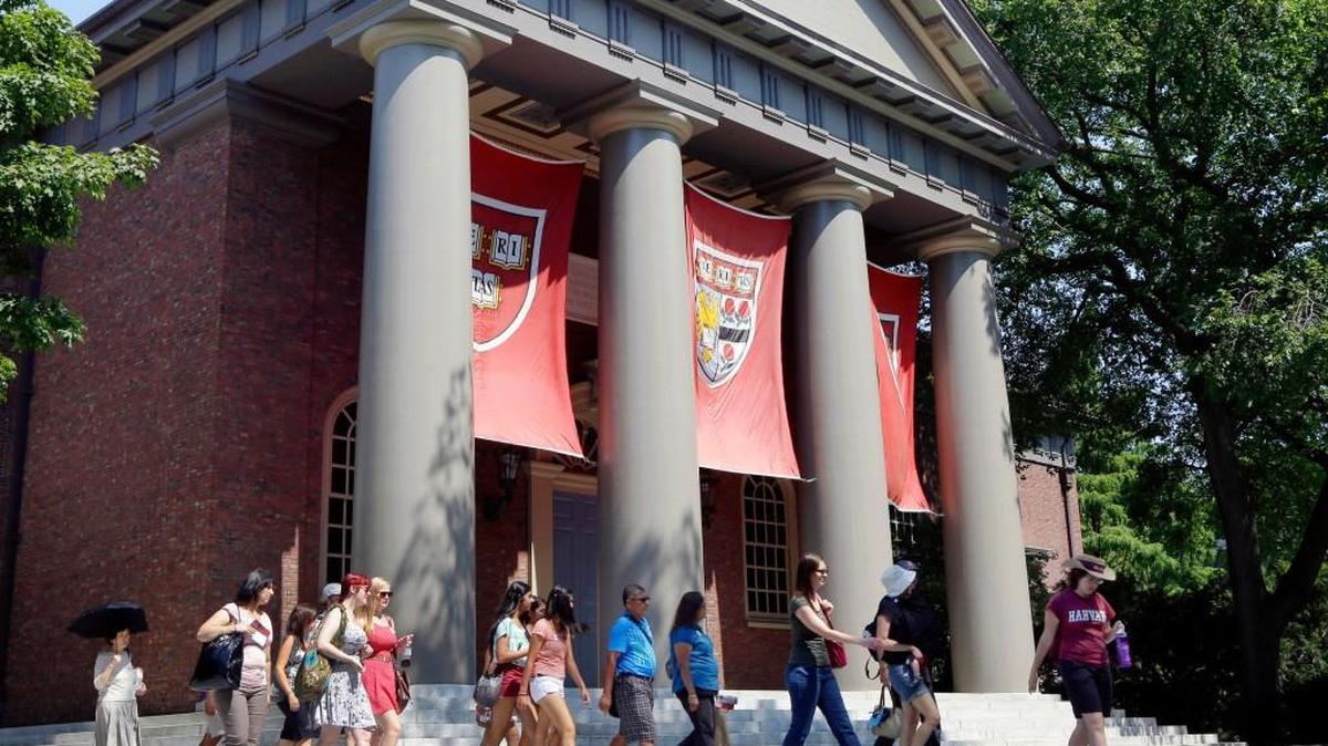 FILE - In this Aug. 30, 2012, file photo, a tour group walks through the campus of Harvard University in Cambridge, Mass. Word of an August 2017 Justice Department inquiry into how race factors into admissions at Harvard University has left top-tier colleges bracing for scrutiny of practices that have boosted diversity levels to new highs. While they keep their selection formulas under wraps, Ivy League colleges defend race-conscious approaches that contributed to a 17 percent increase in nonwhite students over a recent five-year span.
