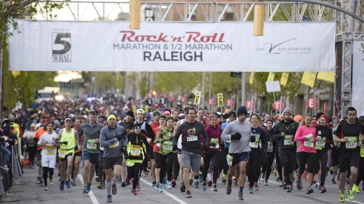 Participants leave from the start line of the Rock 'n' Roll Marathon and Half-Marathon Race in Raleigh on April 10, 2016. Over 7,500 runners registered for the event.