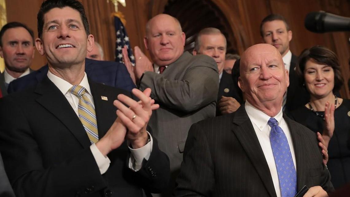 Speaker of the House Paul Ryan (R-WI) (L) and House Ways and Means Committee Chairman Kevin Brady (R-TX) celebrate with fellow House Republicans following the passage of the Tax Cuts and Jobs Act in the Rayburn Room at the U.S. Capitol November 16, 2017 in Washington, DC.