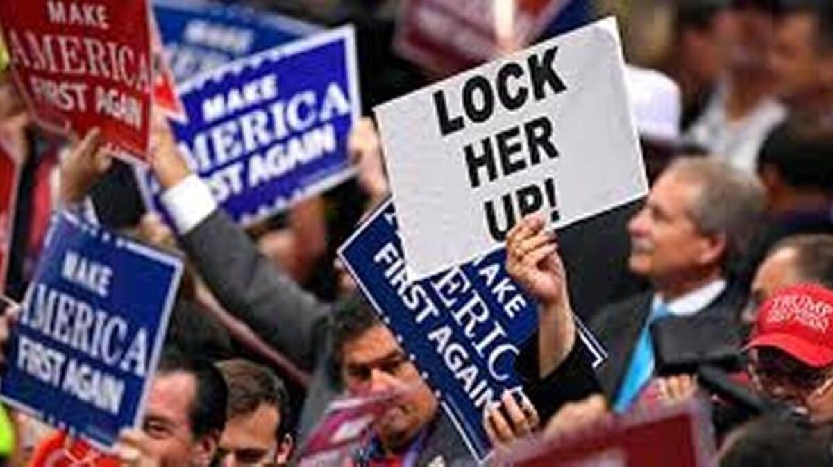 Signs are held by delegates during a musical performance on the third day of the Republican National Convention in Cleveland, Wednesday, July 20, 2016.