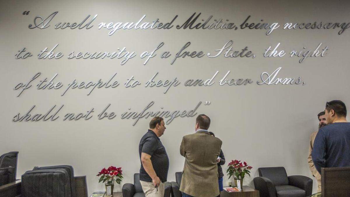 The Second Amendment is emblazoned on the wall at Elite Shooting Sports where Corey Stewart, back to camera, met with supporters at the Manassas, Virginia, shooting range. Stewart, a Republican, is running to unseat Sen. Tim Kaine, a Democrat, who on the same day met with mothers who want stronger gun control.