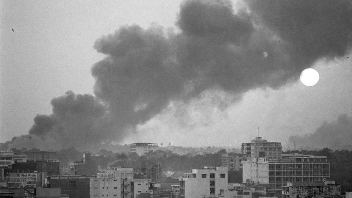 In this 1968 file photo, smoke rises over battle-scarred Saigon during the Tet Offensive as the sun sets over the South Vietnamese capital Saigon.