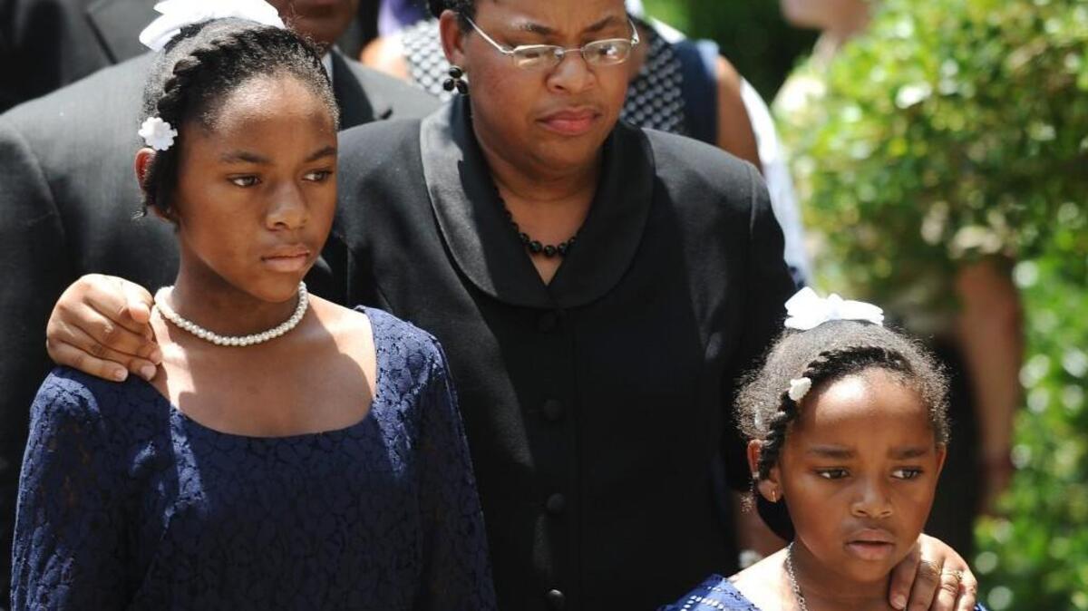 Sen. Clementa Pinckney’s wife Jennifer Pinckney, center, and her daughters, Eliana, left, and Malana follow his casket into the South Carolina Statehouse. Pinckney was one of those killed in a mass shooting at the Emanuel AME Church in Charleston last June.