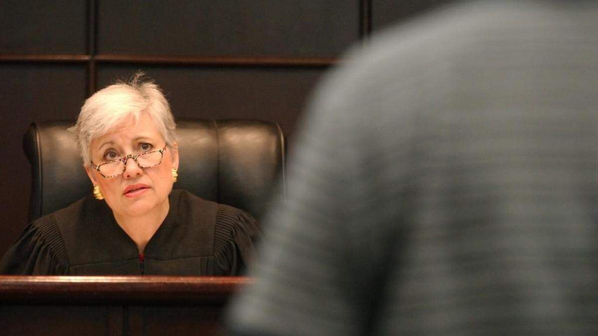 In this file photo, a Wake district court judge reviews an affidavit of indigence with a defendant in her courtroom. The defendant requested a court-appointed attorney, which requires payment of a fee.