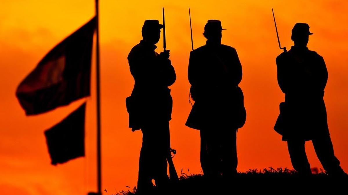 Confederate Army re-enactors stand on the ramparts of Fort Moultrie in Charleston, S.C., as the sun rises on the 150th anniversary of the start of the Civil War. The first shot was fired in Charleston harbor.