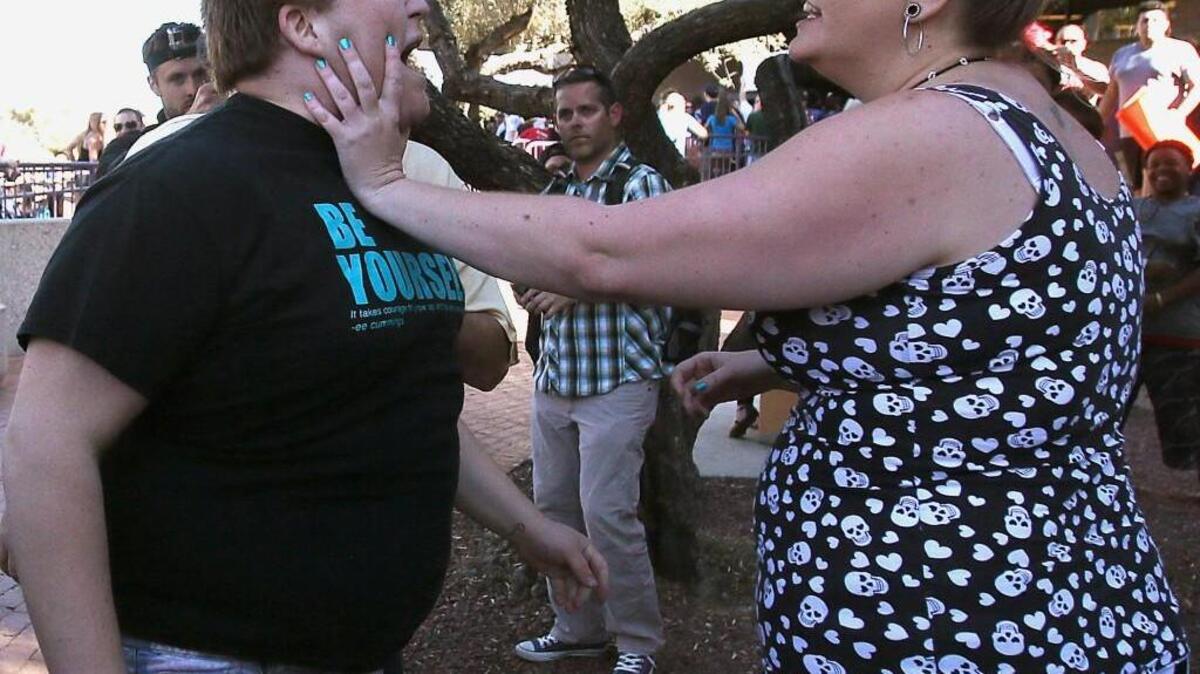A Donald Trump protester and supporter get into an altercation at the conclusion of a Trump rally in March in Tucson, Ariz. Police broke up the fight and both people walked away.