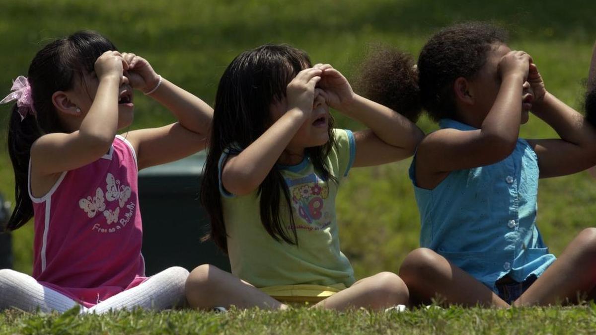 Lakewood Elementary School kindergartners use ‘pretend’ binoculars while watching a Duke University Hospital LifeFlight helicopter land on the school’s soccer field in 2006.