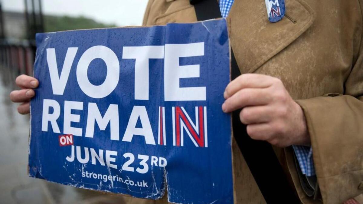 Campaigners in London hold placards seeking to avoid a Brexit, ahead of the forthcoming EU referendum.