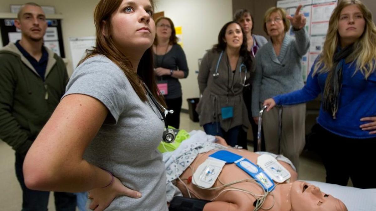 UNC nursing school students watch the monitor as they get hands-on experience with a human patient simulator during a class at the School of Nursing in Carrington Hall on the UNC-Chapel Hill campus.
