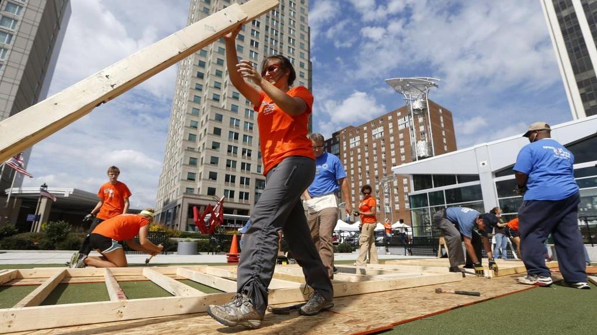 An AmeriCorps member with Habitat works during a Habitat for Humanity Wall Build Wednesday, September 25, 2013, at the Downtown Raleigh Farmers Market. Volunteers put the walls together for a three-bedroom, 1100 square foot home.