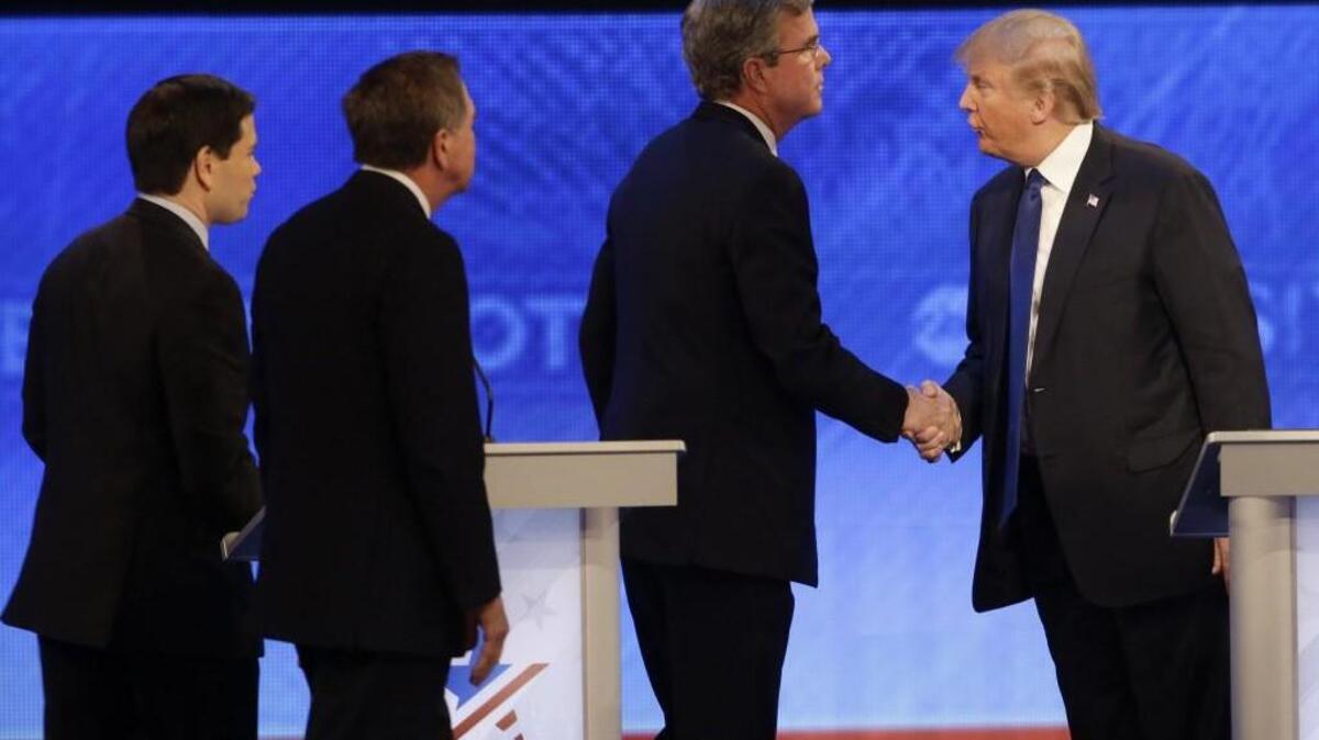 Republican presidential candidate Donald Trump shakes hands with former Florida Gov. Jeb Bush as Sen. Marco Rubio, R-Fla., and Ohio Gov. John Kasich walk past after a Republican presidential primary debate in Manchester, N.H.