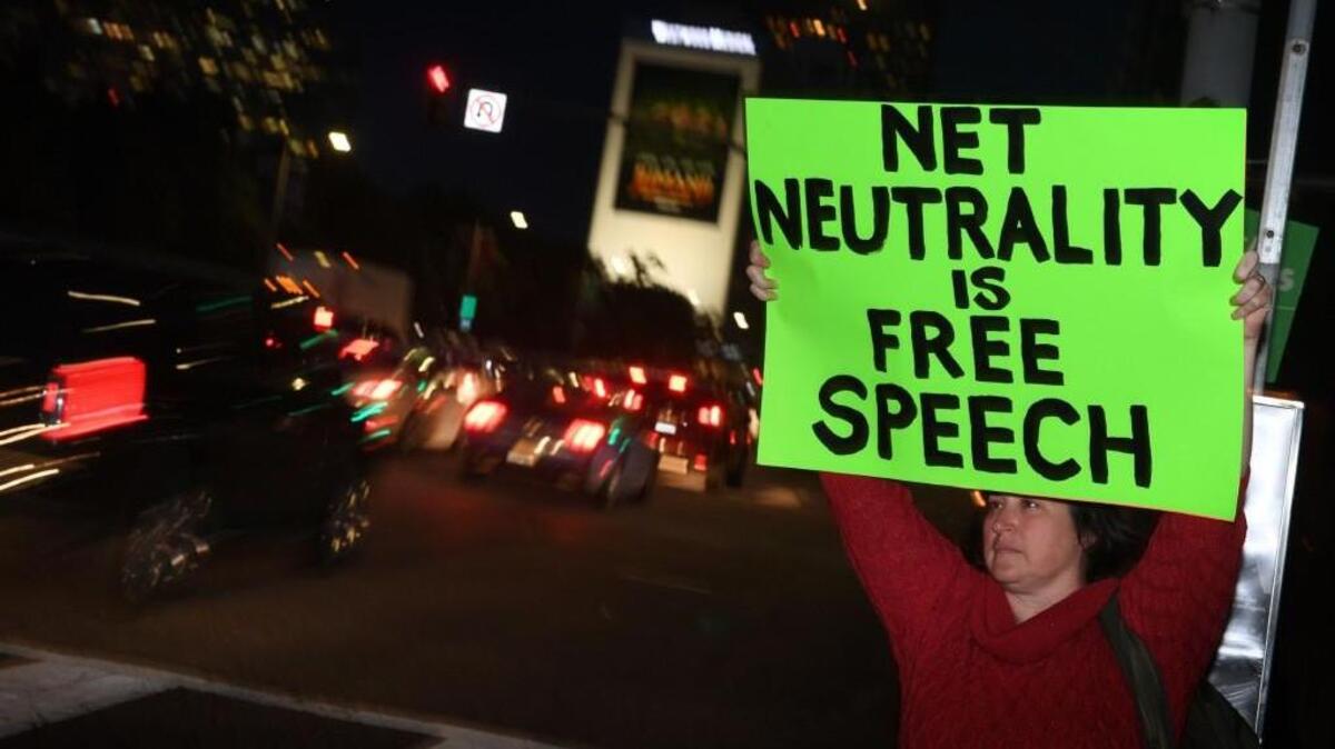 People protest during a rally to 'Protect Net Neutrality' as they voice their opposition to the impending FCC vote, outside the Federal Building in Los Angeles, California on November 28, 2017.