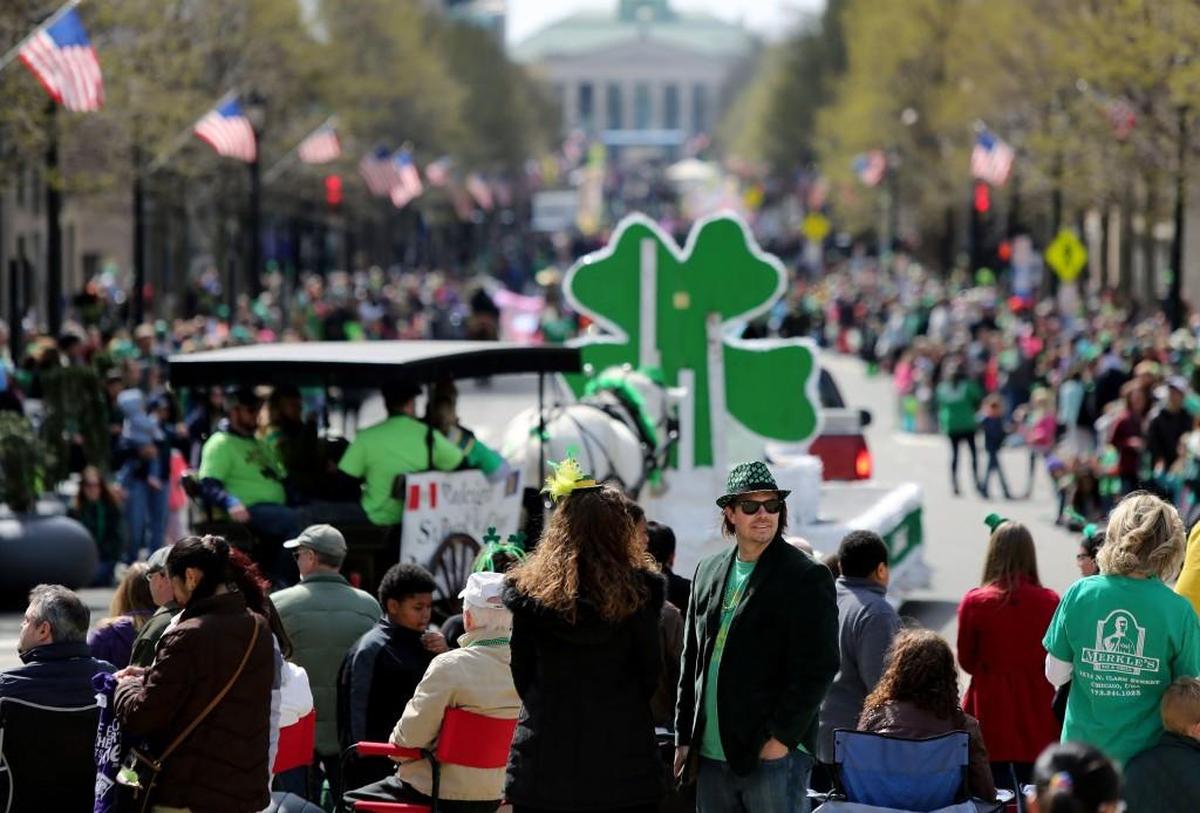 People line the streets of downtown Raleigh to watch the Raleigh St. Patrick’s Day Parade on Saturday, March 11, 2017.