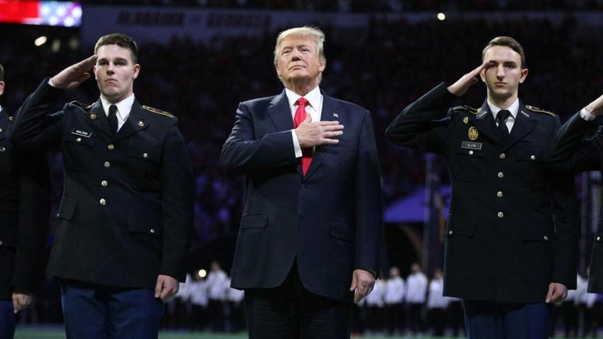 President Donald Trump participates in the national anthem at the College Football Playoff National Championship at Mercedes-Benz Stadium on Monday, Jan. 8, 2018 in Atlant, Ga.