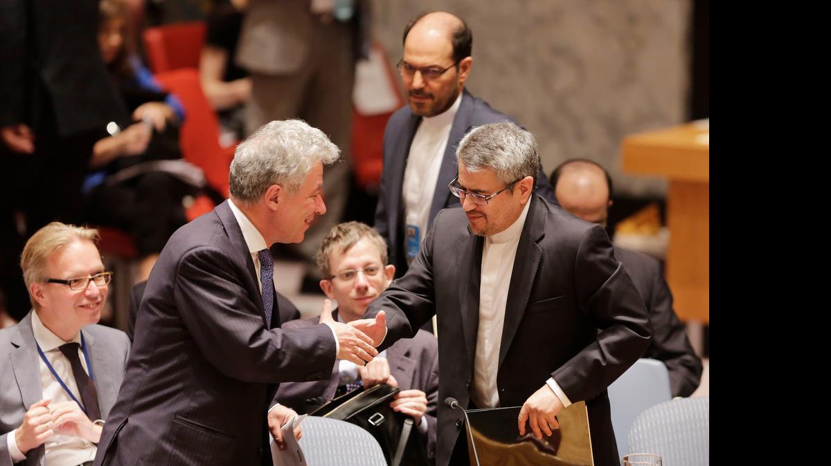 
Thomas Mayr-Harting, left, head of the delegation of the European Union to the United Nations, shakes hands with Iran's U.N. Ambassador, Gholamali Khoshroo, at United Nations headquarters after the U.N. Security Council unanimously endorsed the landmark nuclear deal between Iran and six world powers and authorized a series of measures leading to the end of U.N. sanctions that have hurt Iran's economy.
