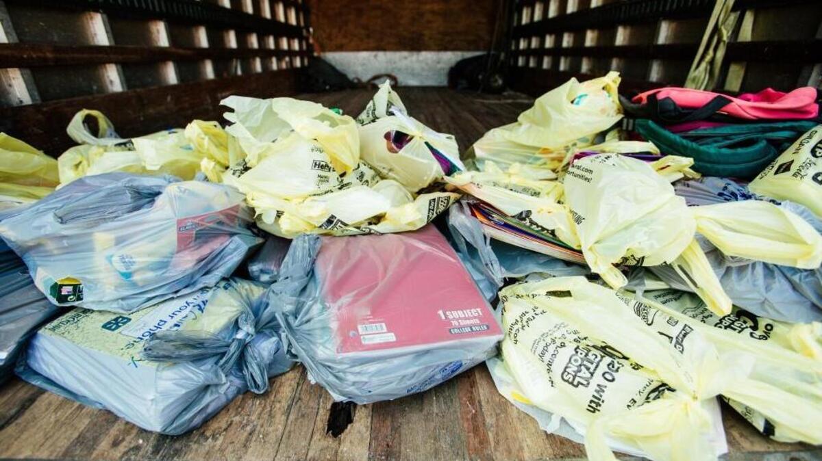 Bags of donated school supplies begin to fill a truck during a drive organized by Raleigh Rescue Mission outside Dollar General in Raleigh, N.C. on Saturday, Jul. 22, 2017.