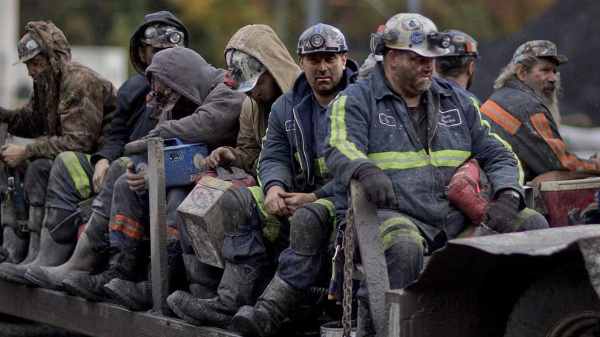 In this Oct. 15, 2014 photo, coal miners return on a buggy after working a shift underground at the Perkins Branch Coal Mine in Cumberland, Ky.