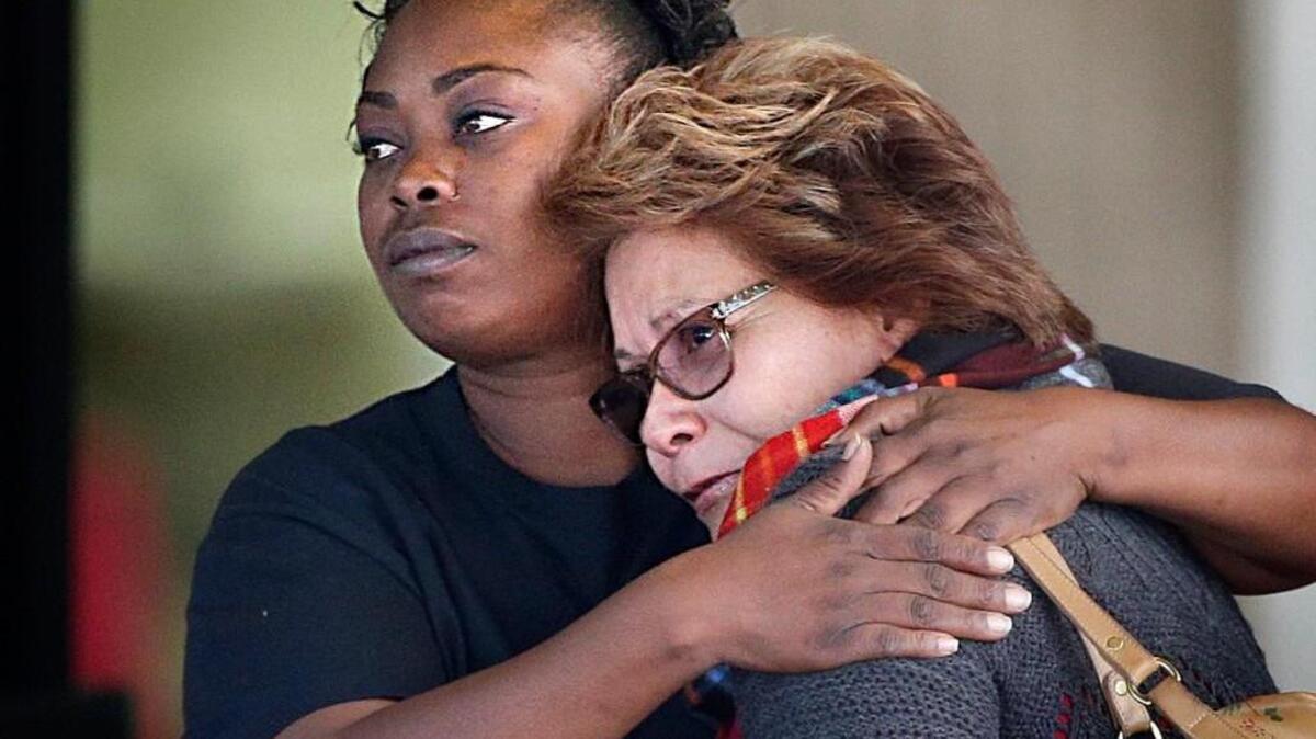Two women embrace at a community center where family members were gathering to pick up survivors after a shooting rampage that killed multiple people and wounded others at a social services center in San Bernardino, Calif.