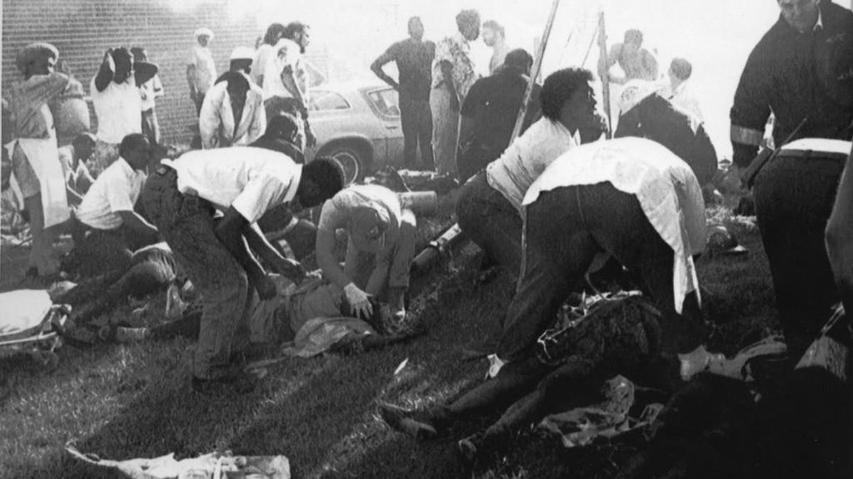 Rescuers aid injured workers of the Imperial Food Products plant in Hamlet after fire ripped through the plant on Sept. 3, 1991.