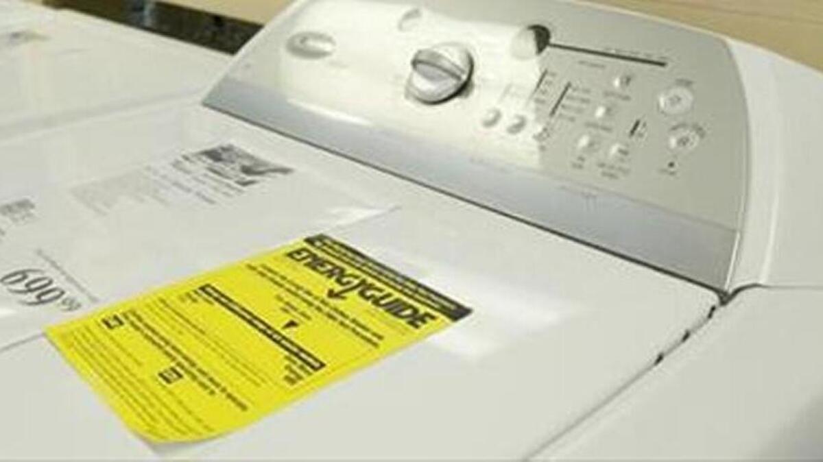 Some Energy Star household appliances, such as this dishwasher, are required to have these yellow tags that indicate how much energy they use each year.