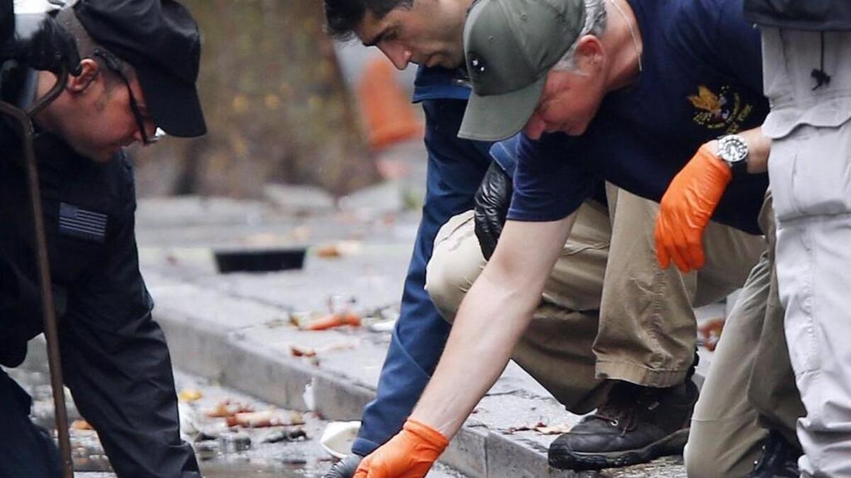 Evidence teams investigate at the scene of the explosion on West 23 Street in Manhattan's Chelsea neighborhood.
