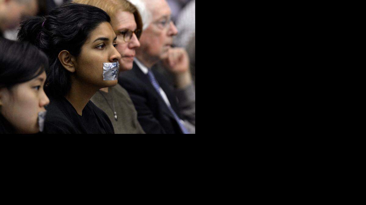 
Some audience members wore duct tape over their mouths during the UNC Board of Governors meeting Friday at UNC Charlotte.
