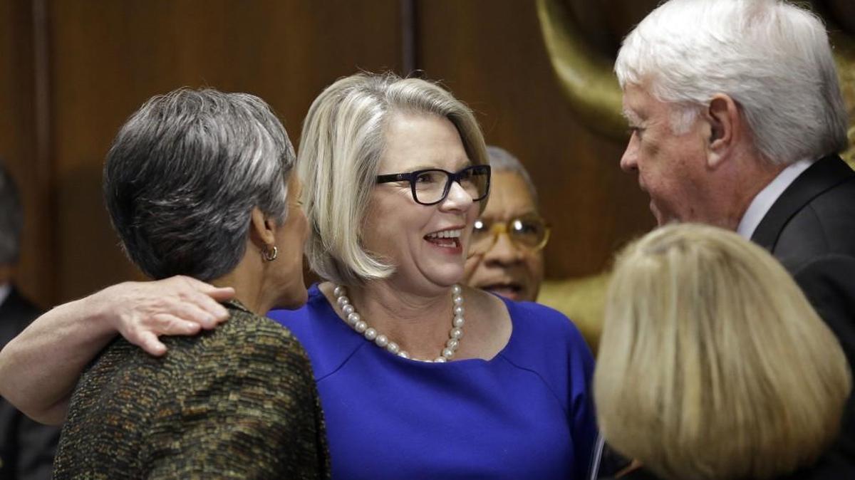 Margaret Spellings is greeted by guests after being introduced during the University of North Carolina Board of Governors meeting in Chapel Hill.