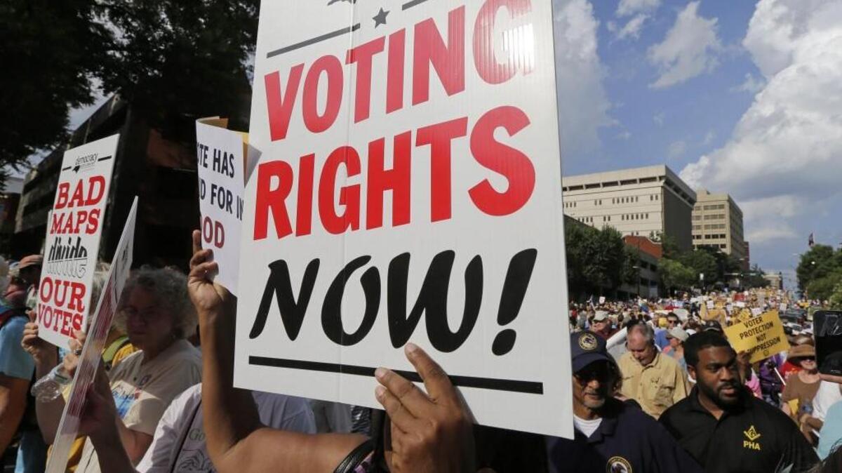 Demonstrators march through the streets of Winston-Salem in 2015 after the beginning of a federal voting rights trial challenging a 2013 state law.
