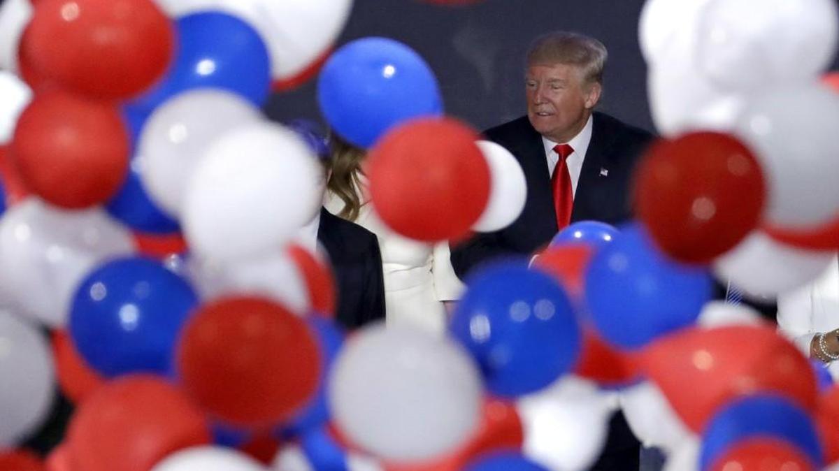 Republican presidential candidate Donald Trump watches balloons fall after his address to delegates during the final day session of the Republican National Convention in Cleveland.