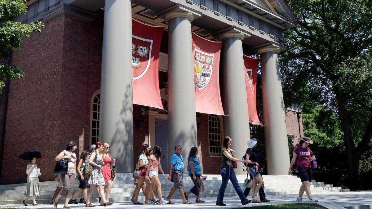 A tour group walks through the campus of Harvard University in August 2012.
