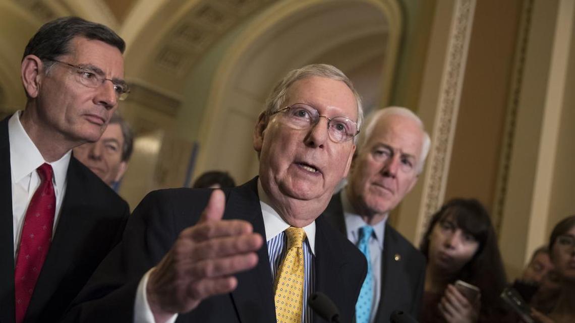 Senate Majority Leader Mitch McConnell, R-Ky., flanked by Sen. John Barrasso, R-Wyo., left, and Majority Whip John Cornyn, R-Texas, meets with reporters at the Capitol in Washington on June 6 to discuss progress on the Senate health care bill. The draft version was released last week.