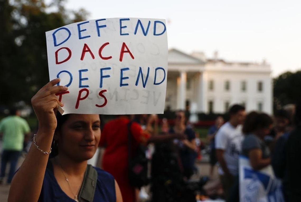 A woman holds up a sign that reads “Defend DACA Defend TPS” during a rally supporting Deferred Action for Childhood Arrivals, or DACA, outside the White House in Washington, Monday, Sept. 4, 2017. TPS stands for “Temporary Protected Status.” A plan President Donald Trump is expected to announce Tuesday for young immigrants brought to the country illegally as children was embraced by some top Republicans on Monday and denounced by others as the beginning of a “civil war” within the party.