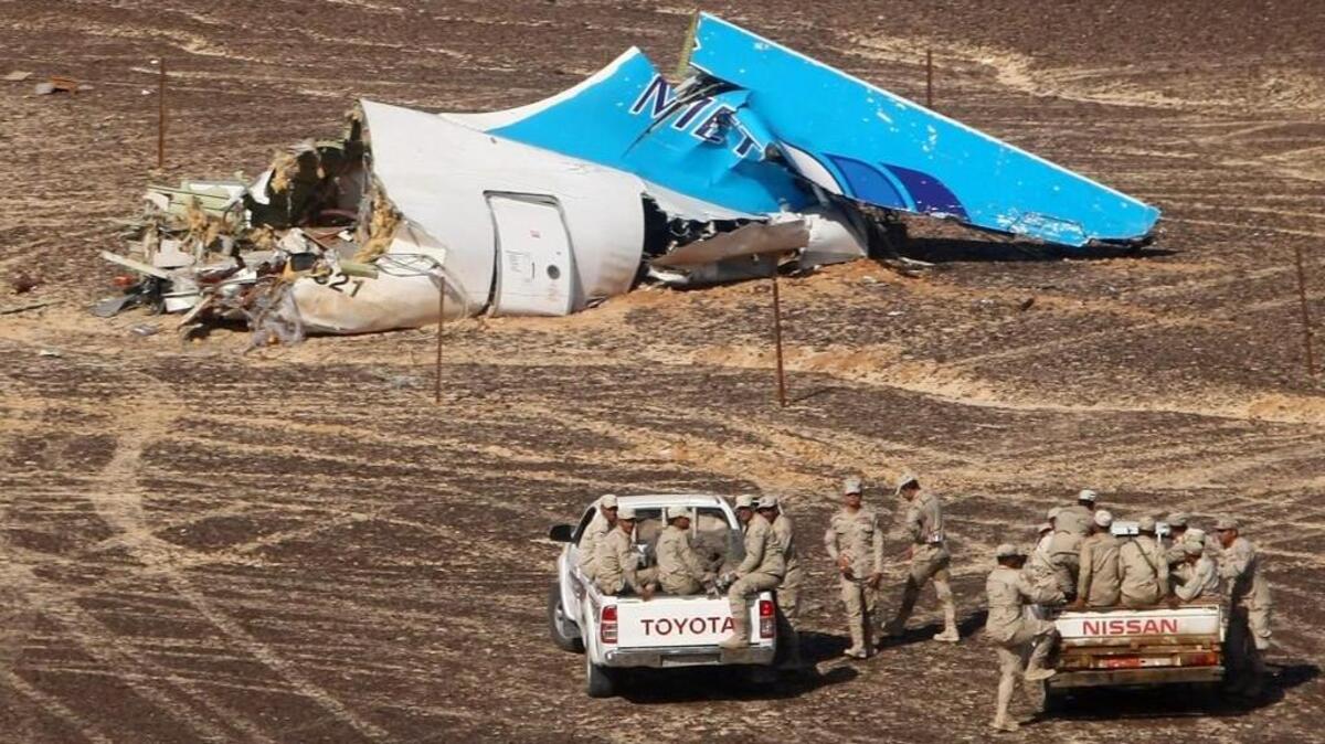 Egyptian military personnel in Hassana inspect the crash site of a jet bound for St. Petersburg, Russia. All 224 people aboard were killed.