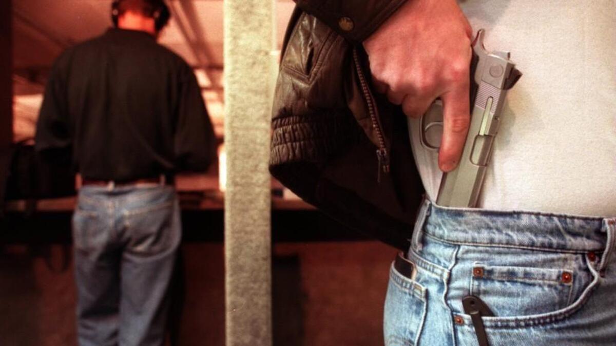 A gun owner displays where he keeps his concealed weapon. The North Carolina Association of Chiefs of Police opposing a NC bill that would ease the requirements for a concealed carry permit.
