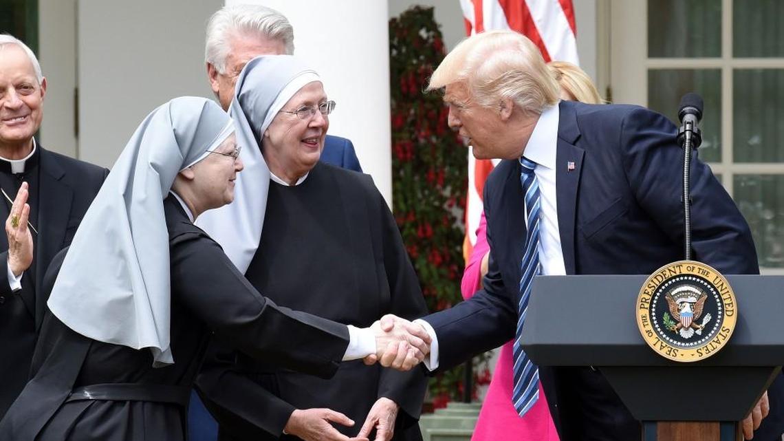 U.S. President Donald Trump greets the Little Sisters of the Poor before signing the Executive Order on Promoting Free Speech and Religious Liberty during a National Day of Prayer Event on Thursday, May 4, 2017 in the Rose Garden of the White House in Washington, D.C.