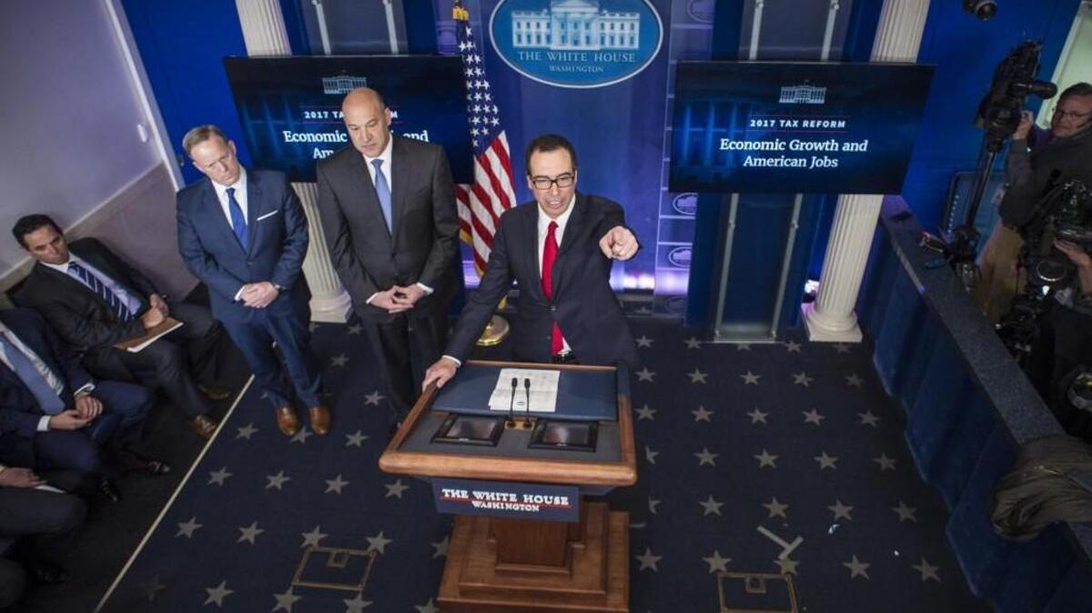 Treasury Secretary Steven Mnuchin, right, joined by National Economic Director Gary Cohn, and White House press secretary Sean Spicer, speaks during a briefing at the White House in Washington on Wednesday.