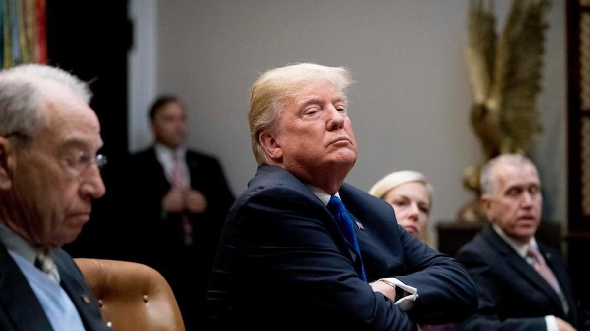 President Donald Trump, center, accompanied by Sen. Chuck Grassley, R-Iowa, left, Secretary of Homeland Security Kirstjen Nielsen, second from right, and Sen. Thom Tillis, R-N.C., right, listens during a meeting with Republican Senators on immigration in the Roosevelt Room at the White House, Thursday, Jan. 4, 2018, in Washington.