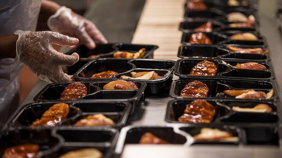 A Meals on Wheels cook moves trays down the line to be packaged Wednesday, March 22, 2017, at the MOW Kitchen, in Savannah, Ga. The Savannah program makes and delivers anywhere from 1,300 to 1,800 meals a day. Proposed budget cuts by President Trump's administration may cut grant funding which heavily supports programs such as Meals on Wheels.