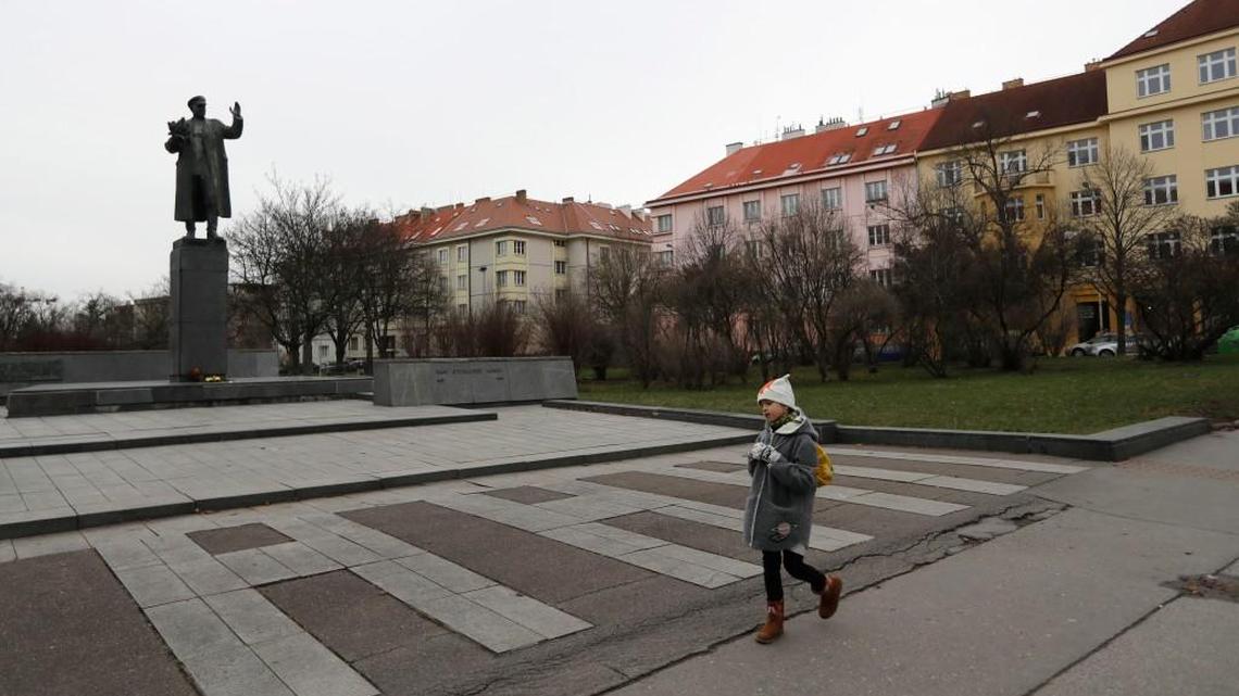 A young girl walks past a monument of Soviet World War II commander Ivan Konev in Prague, Czech Republic, Thursday, Jan. 4, 2018. Russia and four other post-Soviet republics have protested a plan to attach an explanatory text of the role of Konev in history to his monument in Prague.