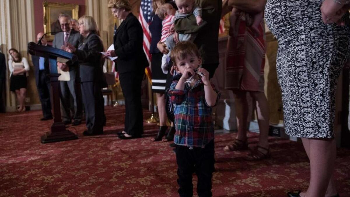 A boy plays with a toy as US Sen. Patty Murray (D-WA) holds a news conference with senators, health experts and local mothers to demand that Congress pass emergency funding to combat the spread of the Zika virus.