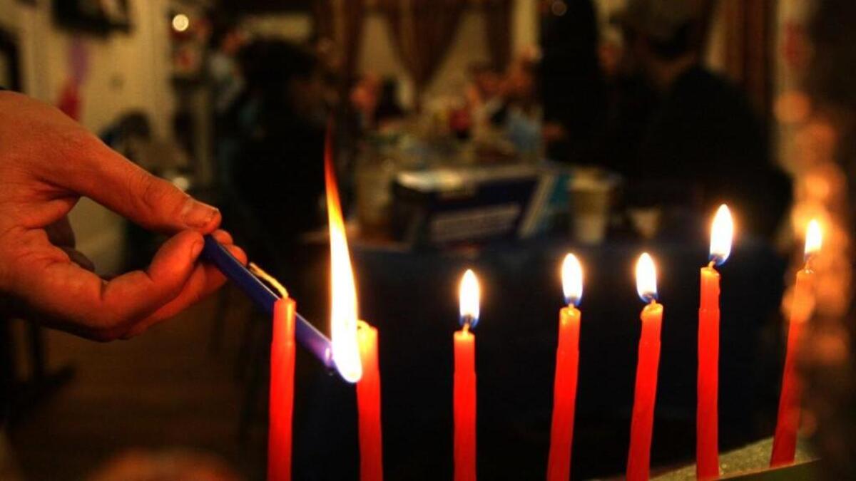 Rabbi Zalman Bluming lights a menorah during a Hanukkah kick-off party in December 12009,.