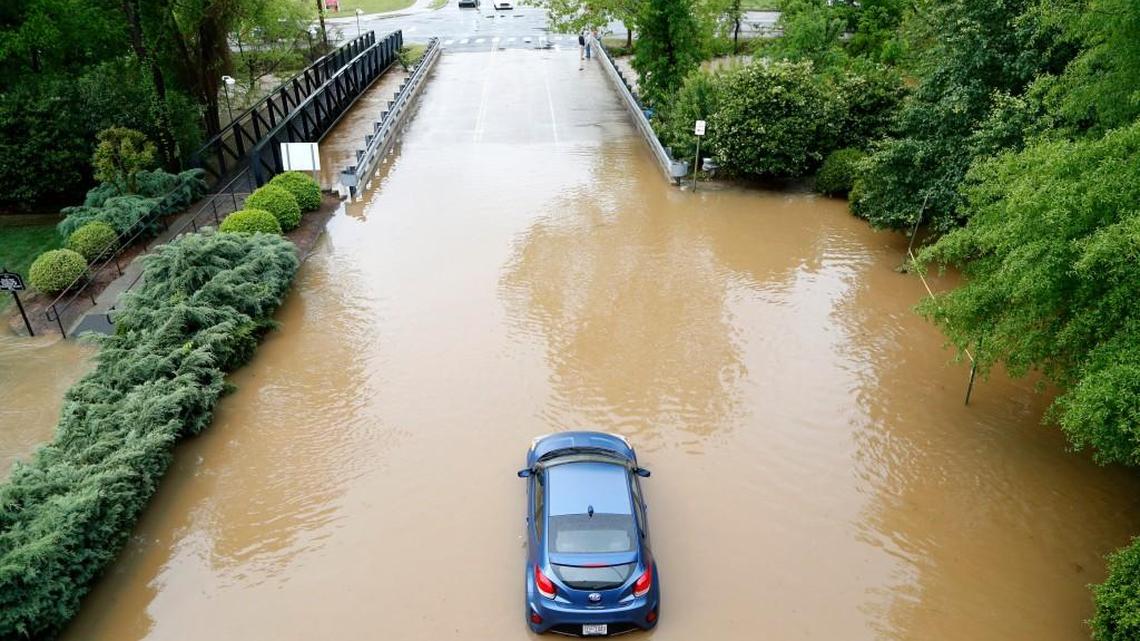 One vehicle lies stranded by the bridge leading into the back side of Crabtree Valley Mall off Crabtree Ave. in Raleigh, NC, on Tuesday morning, April 25, 2017. Heavy rains all day Monday and through the night caused a lot of flooding in the area as creeks and rivers overflowed. The mall was closed Tuesday due to the floods.