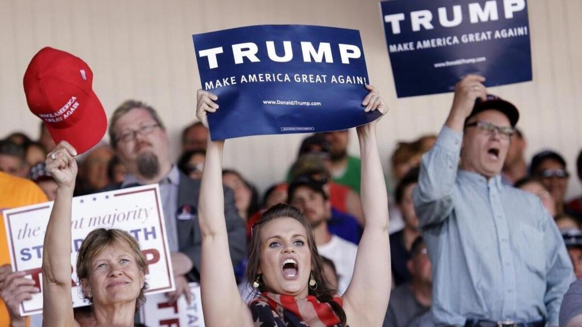 Spectators cheer as Republican presidential candidate Donald Trump speaks in Lynden, Wash.