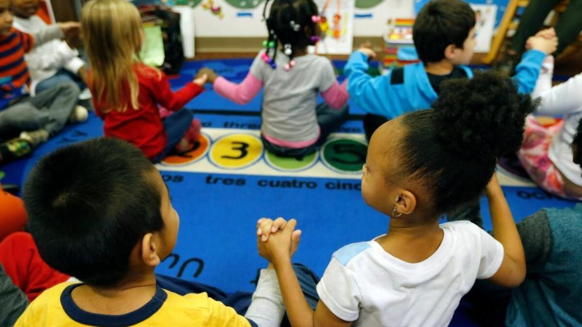 Preschool students join hands as teachers use puppets to help improve classroom management and student behavior while building children's social-emotional skill and positive behavior skills at Hillandale Elementary School in Durham, NC. It is part of a program being developed in cooperation with the Duke Center for Child & Family Policy.