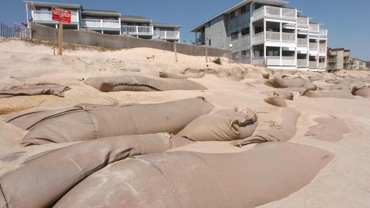 Sandbags line the beach in front of condominiums at Kure Beach in 2008. Sandbags were originally meant to offer threatened structures temporary protection, generally for two years, until a more permanent solution could be developed.
