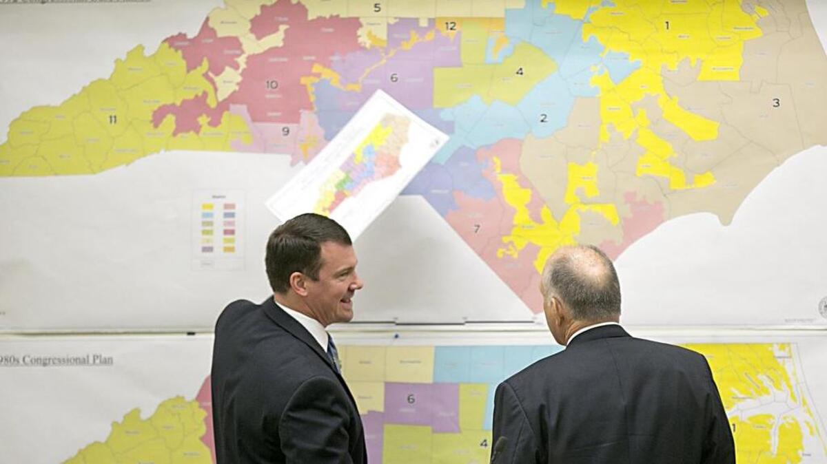 Senators Dan Soucek, left, and Brent Jackson, right, review historical district maps during The Senate Redistricting Committee for the 2016 special session in the Legislative Office Building.