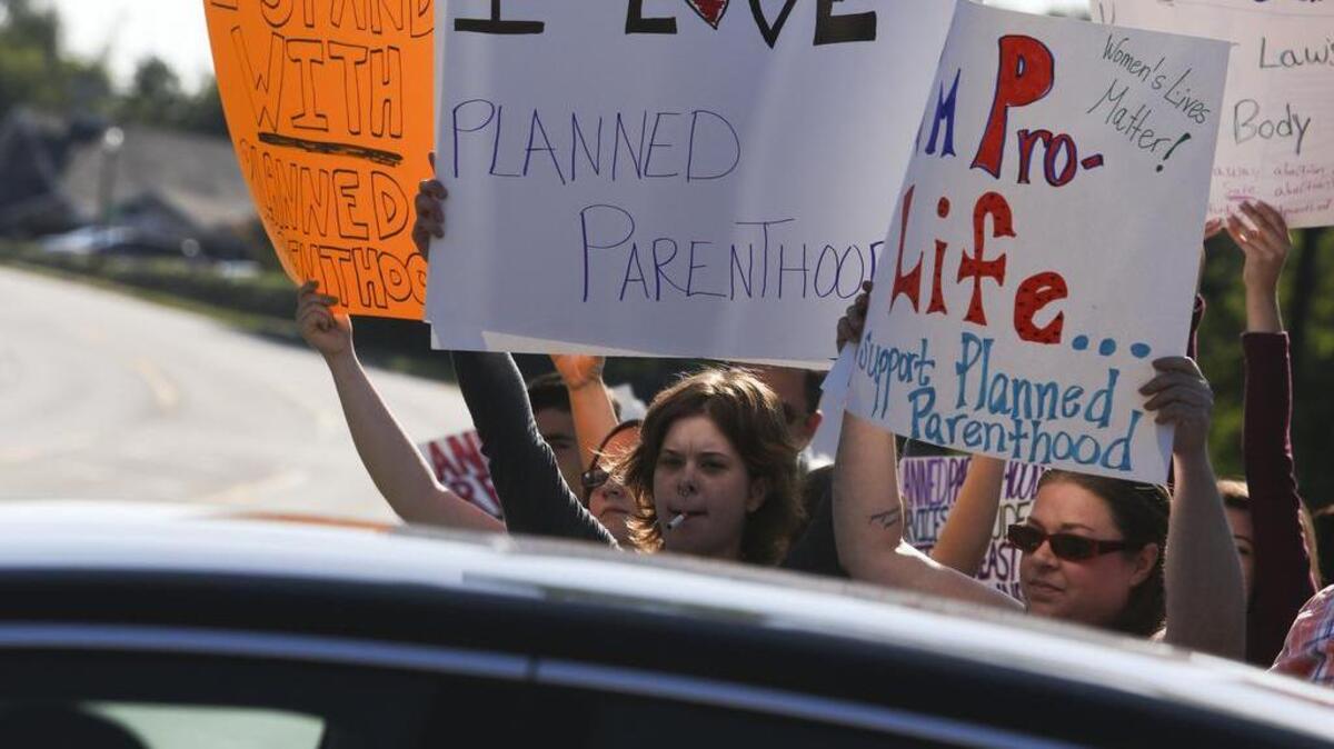 
A handful demonstrators support Planned Parenthood as anti-abortion activists hold a protest across the street in Kalamazoo, Mich.

